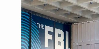 FBI sign on building facade behind metal fence