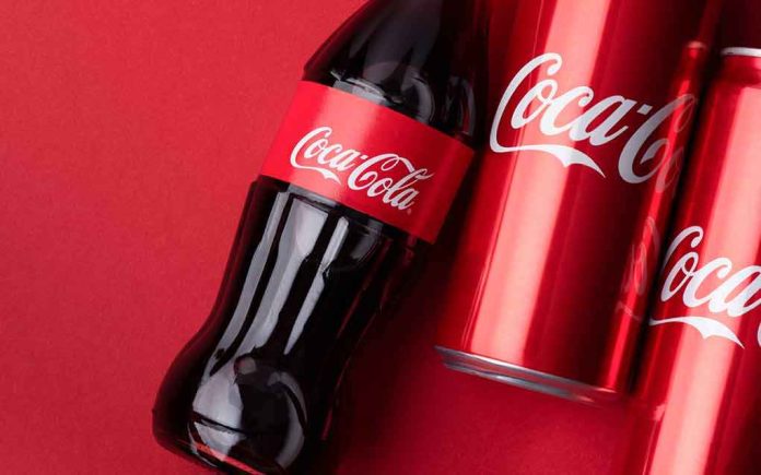 shutterstock_1939168312 Coca-Cola bottle and cans on red background
