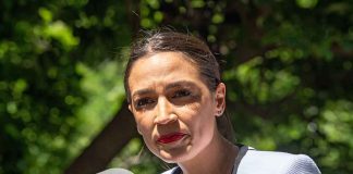 TV Host TORCHES AOC — What HE SAID! woman speaking at an outdoor microphone