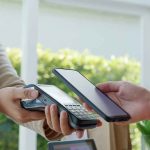 Nation’s Top Wage EXPLODES — How Can THEY DO IT?? Customer paying with smartphone at contactless card reader