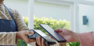Customer paying with smartphone at contactless card reader