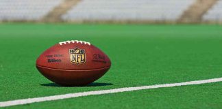 FBI Busts ‘49ers’ Love CON American football on a green field near a white line