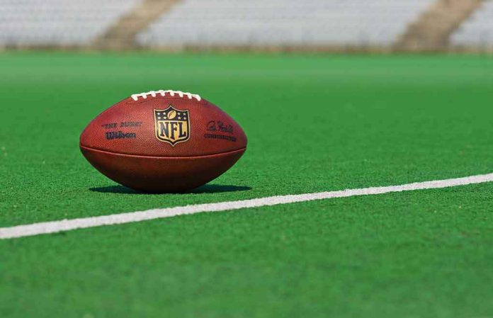 American football on a green field near a white line