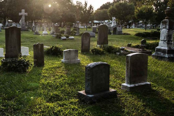 shutterstock_313803443 Gravestones in a sunlit cemetery