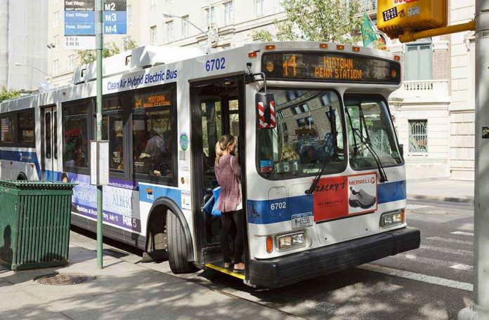shutterstock_322498121 A woman boarding a clean air hybrid electric bus at a city stop