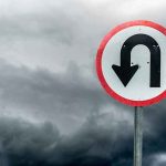 STUNNING U-Turn — ALL CHARGES DROPPED! U-turn road sign against dark stormy sky