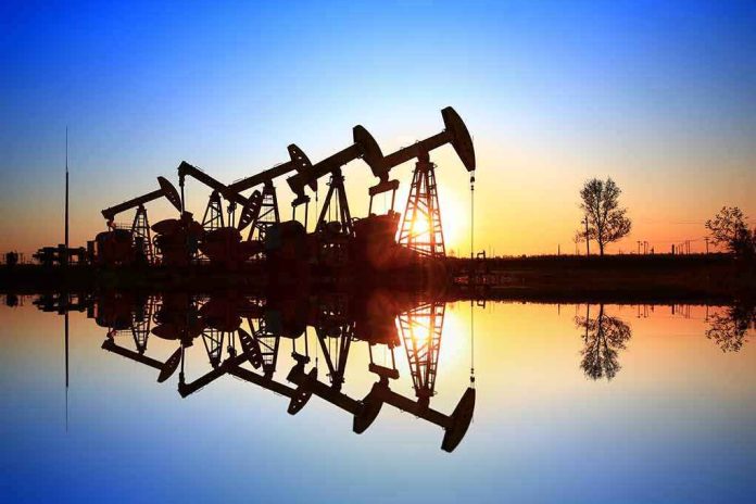 shutterstock_654956419-1 Oil pumpjacks at sunset reflected in still water