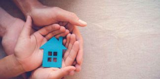 Inflation DIPS — Anomaly or TREND? Hands holding a blue house cutout