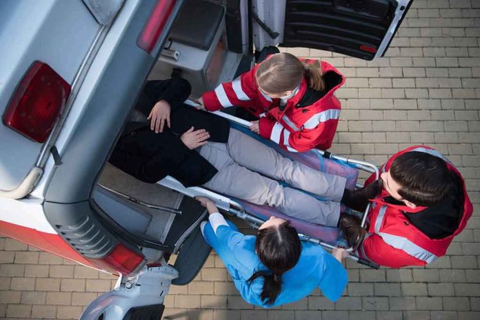 shutterstock_766454218-1 Paramedics load a patient on a stretcher into an ambulance