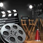 Bond’s Fate: Who’s the Next 007? Movie set with film reels and clapperboard.