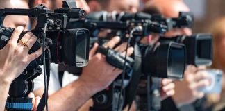 television cameras on tripods at a media event