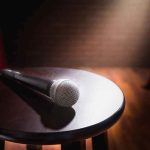 Daytime Star Bragged On Air — Then Someone Checked The RECORD Microphone on a round stool under stage spotlight