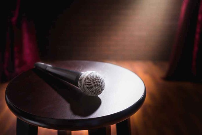 shutterstock_1008642364 Microphone on a round stool under stage spotlight