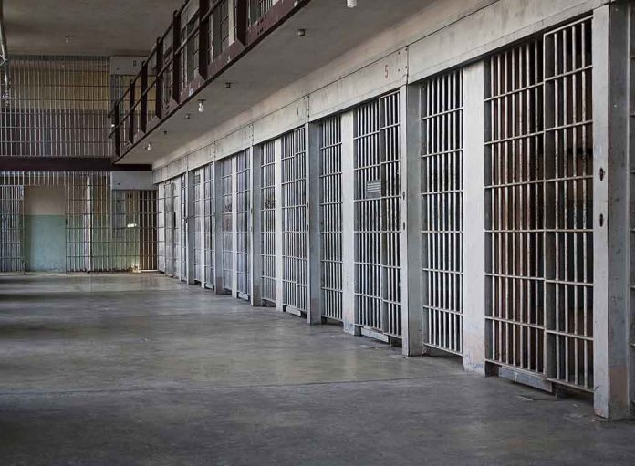 shutterstock_100994692 prison cell block with metal barred doors