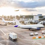 The FAA Froze Newark’s Flights — By Lunch Two More Airports FELL Airplanes at airport gates during sunset with ground vehicles and jet bridges
