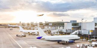 The FAA Froze Newark’s Flights — By Lunch Two More Airports FELL Airplanes at airport gates during sunset with ground vehicles and jet bridges