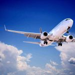 Boeing Warned Airlines About A Flaw Weeks Ago — Nobody Warned YOU Commercial airplane flying with landing gear extended against a blue sky