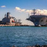 A Veteran Billed The Navy $9 Million — Wait Until You See For WHAT Aircraft carrier and support ships docked at a naval harbor