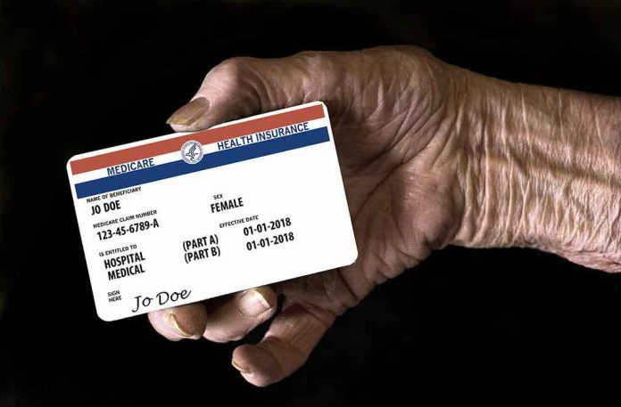 shutterstock_1206430648-1 Elderly hand holding a health insurance card