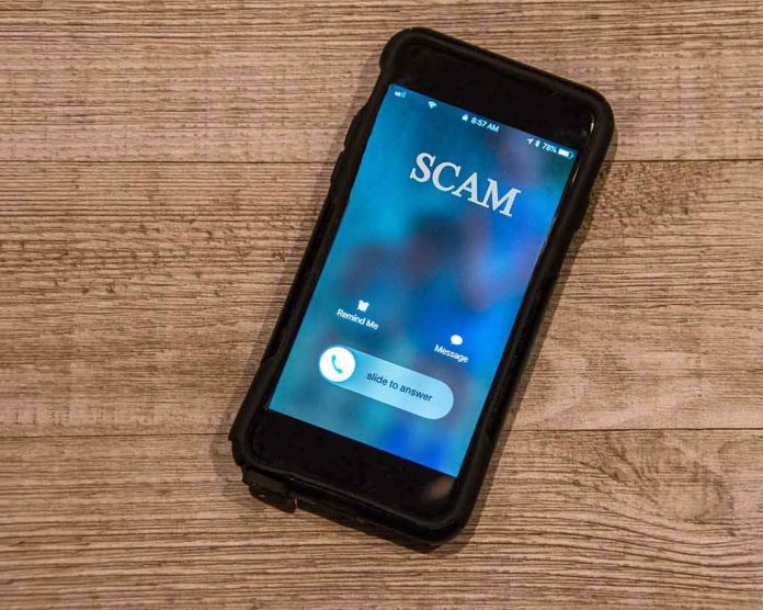 shutterstock_1252782130-1 Smartphone showing an incoming scam call on a wooden surface