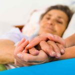 Shocking Betrayal: Perry’s Assistant Injected Fatal Dose Caregiver holding hands with an elderly patient in bed