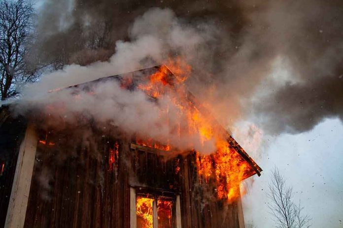 shutterstock_1651851238 Wooden house engulfed in flames and thick smoke