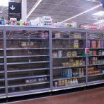 Partially empty store shelves with baby formula and supplies
