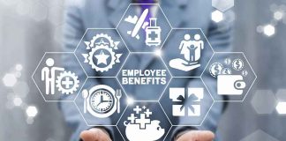 Businessperson holding icons of employee benefits above a smartphone