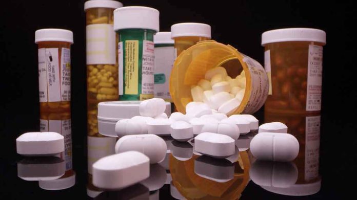 Prescription pill bottles and spilled white tablets
