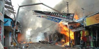 Street marketplace engulfed in fire and heavy smoke