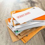 Stack of mail with past due notice on top