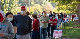 Christian Jones and others waiting in a long line outside a polling place