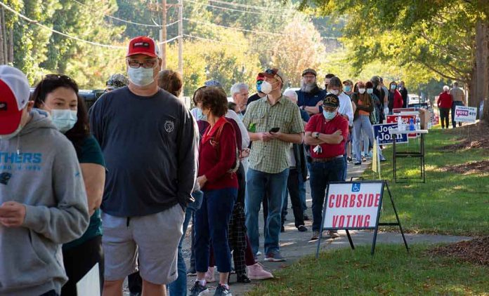 shutterstock_1834288405 Christian Jones and others waiting in a long line outside a polling place