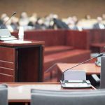 ELITES TORCHED Over Grooming HORROR Courtroom with empty witness stand and microphones