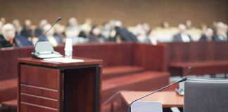 Courtroom with empty witness stand and microphones
