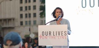 Just 16 Votes — And The Answer Was SHOCKING woman speaking at a podium during an outdoor event