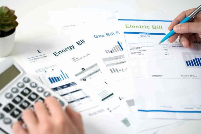 Hands reviewing utility bills with calculator and pen