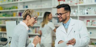 Pharmacist assists customer at pharmacy counter