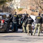 A Gunman Rammed A Deputy’s Car — Then He Aimed HIGHER Police and sheriff officers gather around vehicles on a suburban street