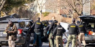 A Gunman Rammed A Deputy’s Car — Then He Aimed HIGHER Police and sheriff officers gather around vehicles on a suburban street