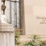 Department of Justice building facade with stone sign and window