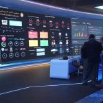 Pentagon Breach Took A TWIST — YOUR Family May Be In The Files cybersecurity operations room with large data dashboards and people discussing