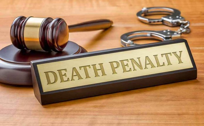 shutterstock_346370309 Gavel, handcuffs, and a nameplate reading death penalty on a wooden desk