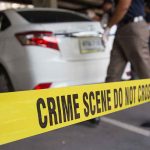 Ruthless Garage Assault Shocks Minneapolis—Who’s Behind It? Yellow crime scene tape in front of a white car with investigators nearby
