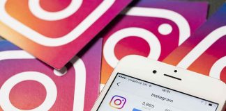 Smartphone showing Instagram profile on colorful logo cards