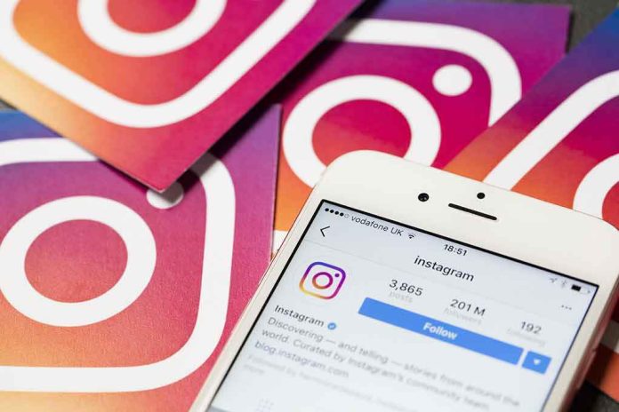 shutterstock_529915960 Smartphone showing Instagram profile on colorful logo cards