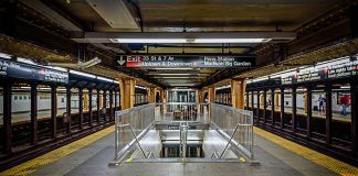 Subway platform with stairwell and tracks on both sides