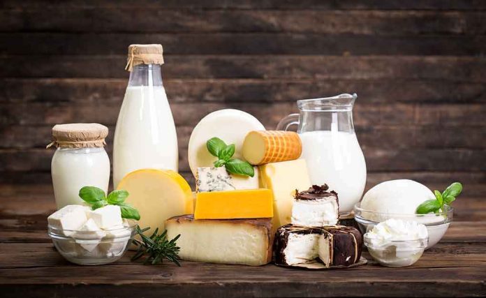 shutterstock_627224804 Assorted dairy products with milk and cheeses on a wooden table