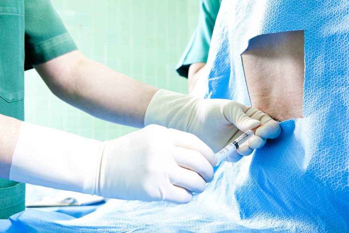 shutterstock_95481631 Healthcare professional administering an injection to a patient in a surgical setting