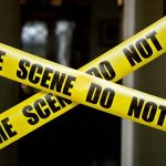 Mom FOUND Dead — Son CHARGED For What He COLLECTED Yellow crime scene tape crossing a doorway